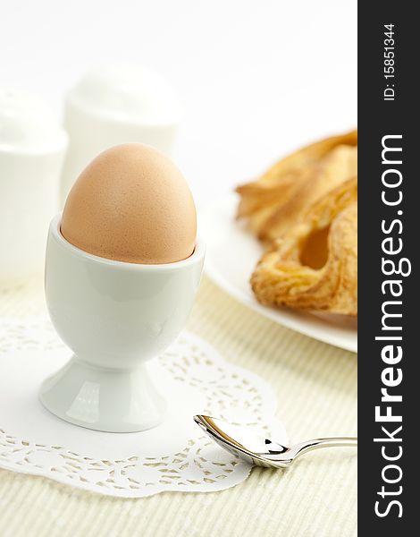 Breakfast table with egg and croissant