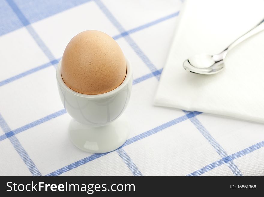 Breakfast table with a fresh egg