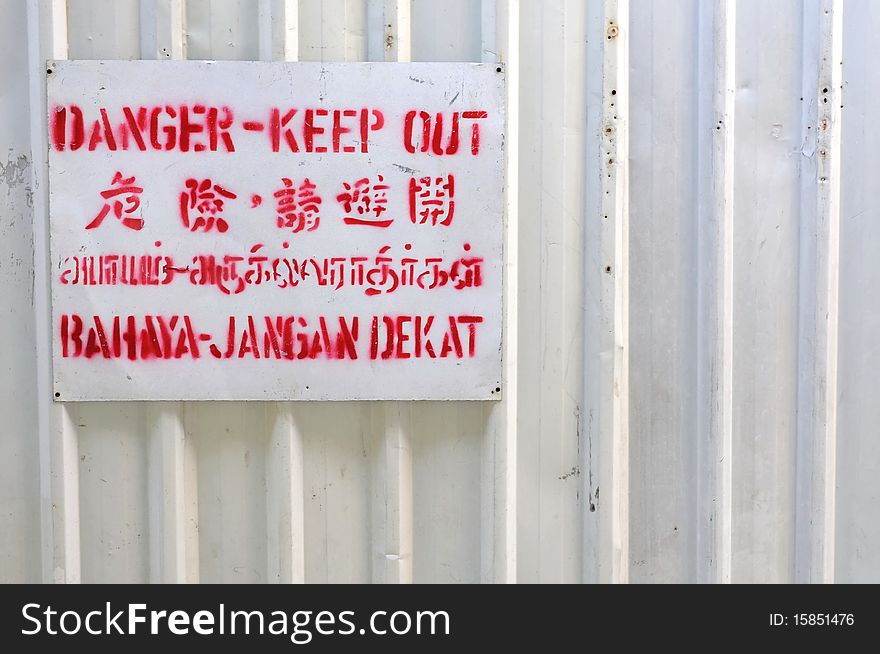 Danger Signboard On White Fence