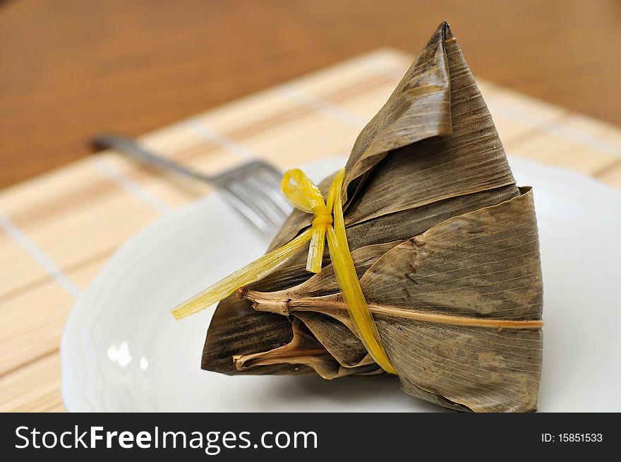 Chinese traditional meat dumpling wrapped in bamboo leaf. For food and beverage, customs and traditions, and local and creative cuisine concepts. Chinese traditional meat dumpling wrapped in bamboo leaf. For food and beverage, customs and traditions, and local and creative cuisine concepts.