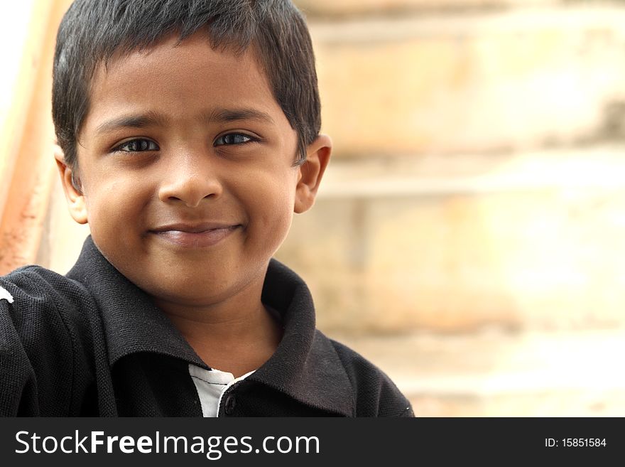 Smiling Cute Indian Boy Posing To The Camera