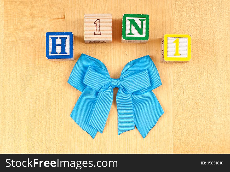 Toy Blocks Spelling H1N1 with Blue Ribbon