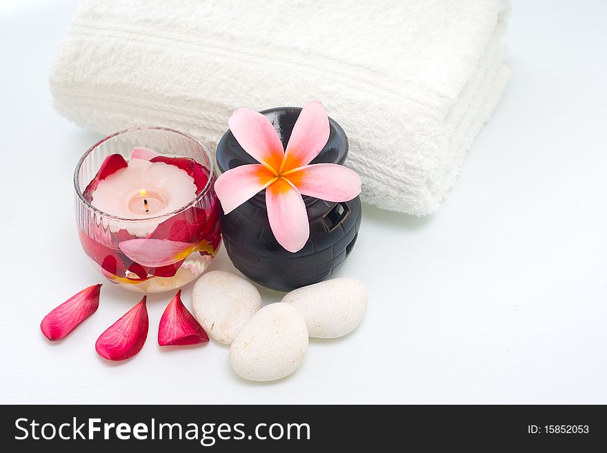 Plumeria flower, white stone, towel and candles for the traditional treatment. Plumeria flower, white stone, towel and candles for the traditional treatment