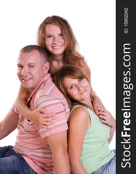 Happy family. Mother, father and little daughter are smiling . Woman, man and girl are lying on the floor and posing happily on white background. Happy family. Mother, father and little daughter are smiling . Woman, man and girl are lying on the floor and posing happily on white background.