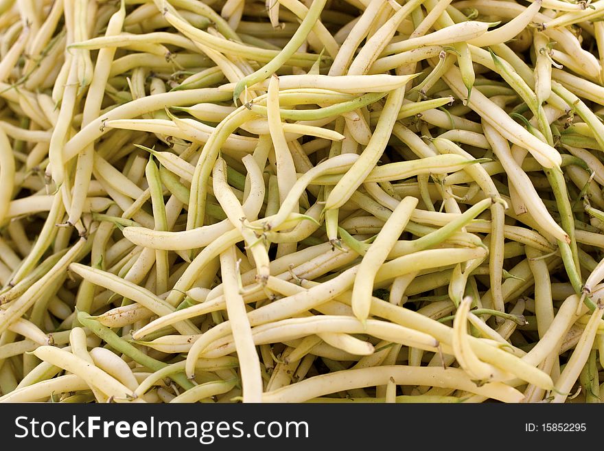 A hip of pale yellow beans on the farmer's market
