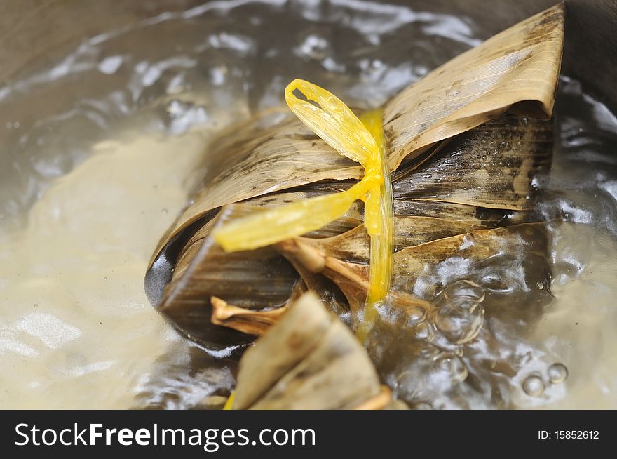 Close up of Chinese traditional meat dumpling wrapped in bamboo leaf and boiling in pot. For food and beverage, customs and traditions, and local and creative cuisine concepts. Close up of Chinese traditional meat dumpling wrapped in bamboo leaf and boiling in pot. For food and beverage, customs and traditions, and local and creative cuisine concepts.