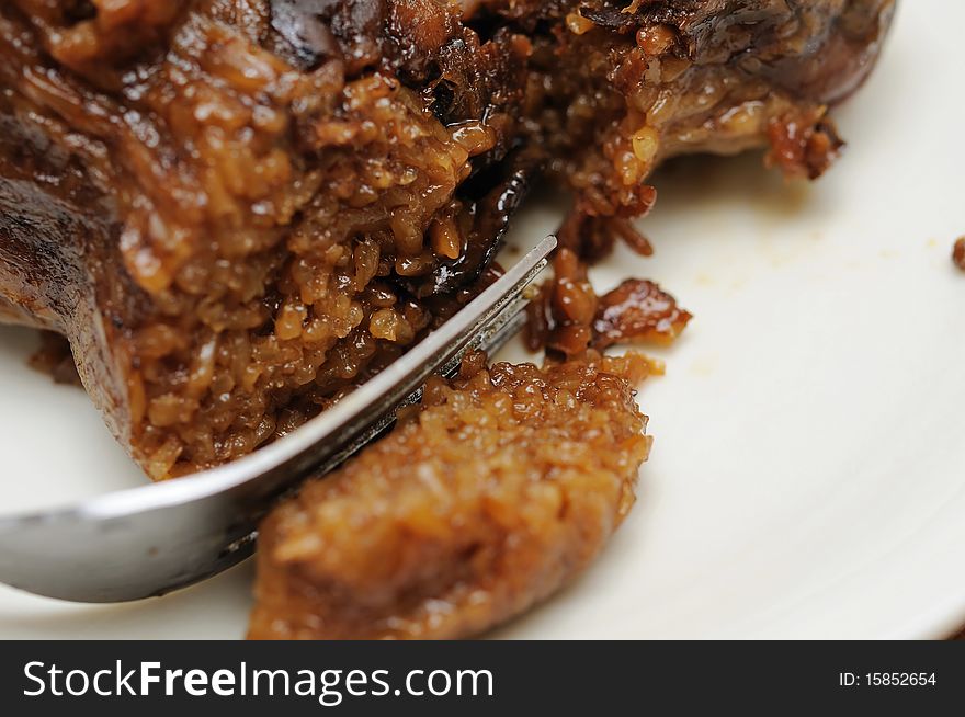 Macro shot of fork on delicious meat dumpling. For food and beverage, customs and traditions, and local and creative cuisine concepts. Macro shot of fork on delicious meat dumpling. For food and beverage, customs and traditions, and local and creative cuisine concepts.