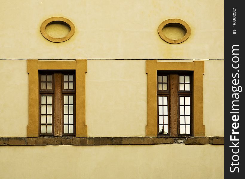 Windows and Oval Frames on a Wall in Italy