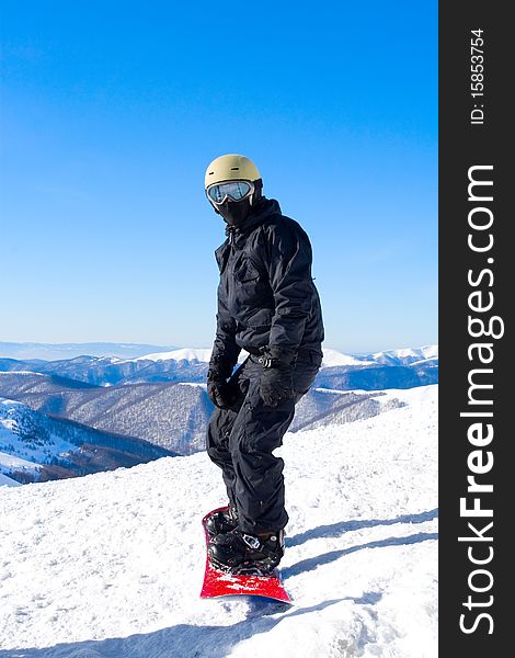 Snowboarder boy in Carpathian mountains