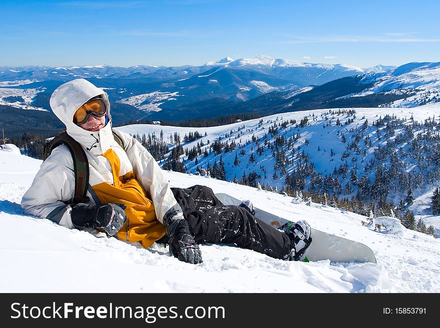 Snowboarder boy in Carpathian mountains