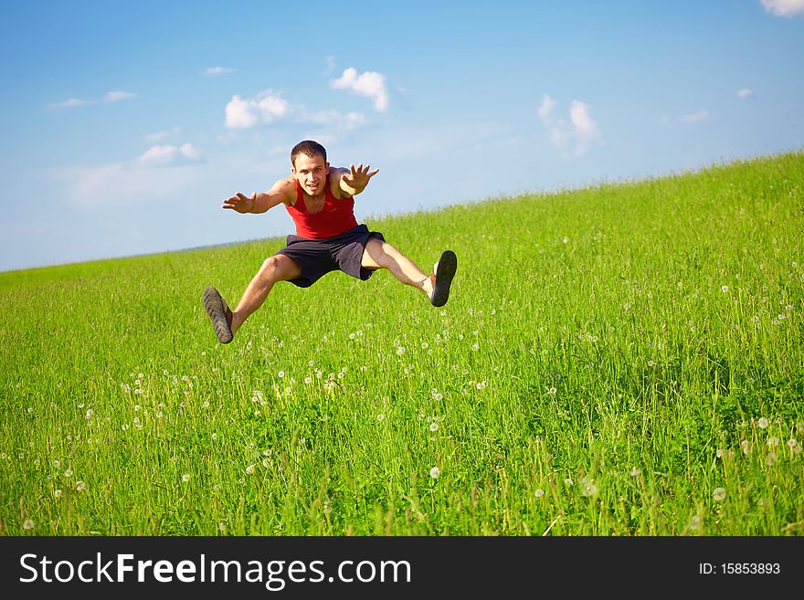 Young man jumps into the field
