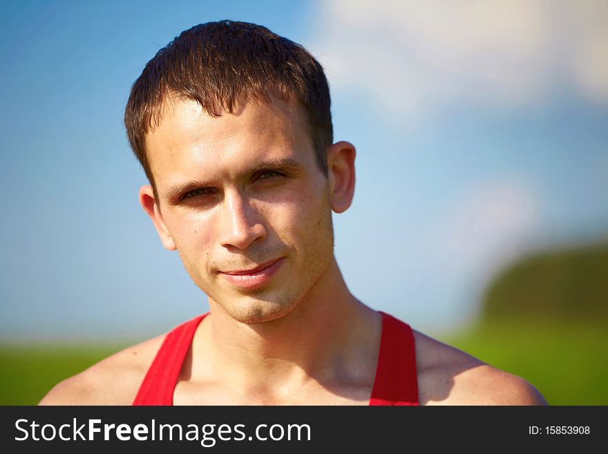 Portrait of a young man against the sky