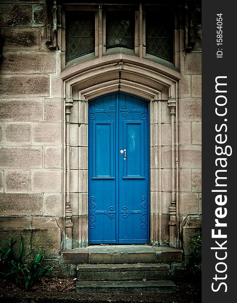 An entrance to an old building with a blue door. An entrance to an old building with a blue door.