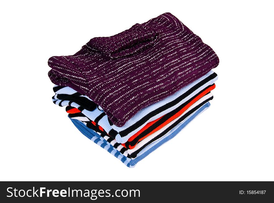 Stack of warm,modern sweaters isolated on a white background. Stack of warm,modern sweaters isolated on a white background.