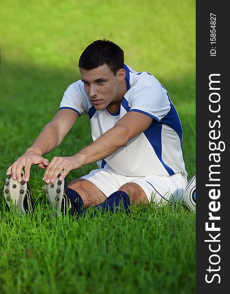 Young soccer player on green grass