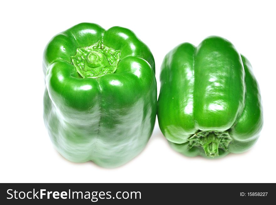 Two green sweet paprika isolated on the white background. Two green sweet paprika isolated on the white background