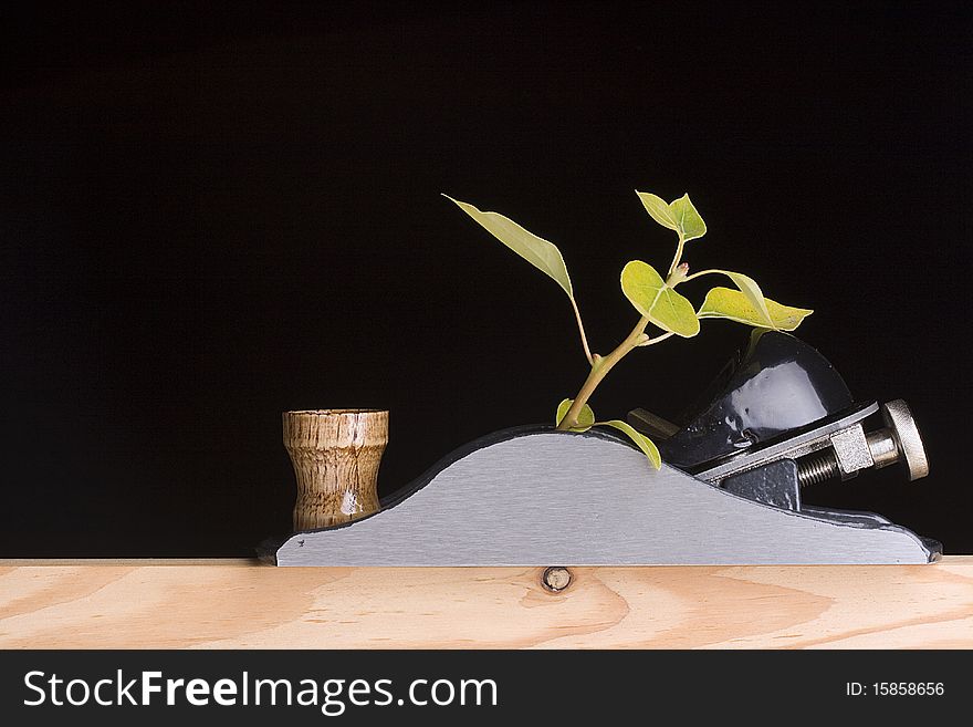 Handplane destroying a young tree on a black background. Handplane destroying a young tree on a black background.