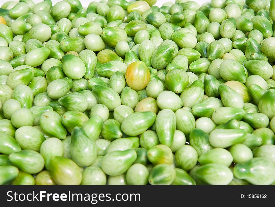 A background of fresh vine green tomatoes for sale at a market