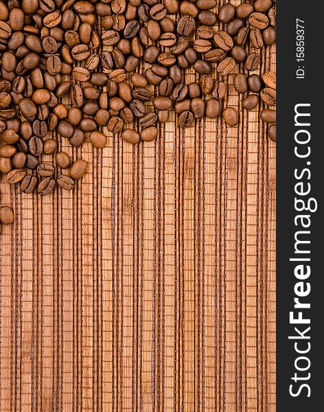 Coffee beans on the wooden background