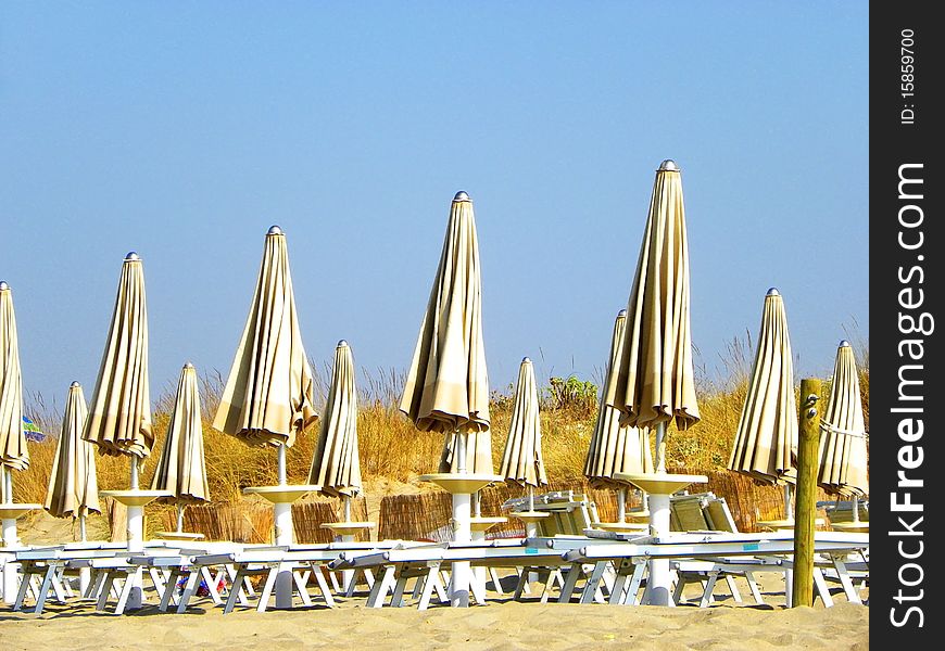 Beach umbrellas and chairs in a beach of Salento