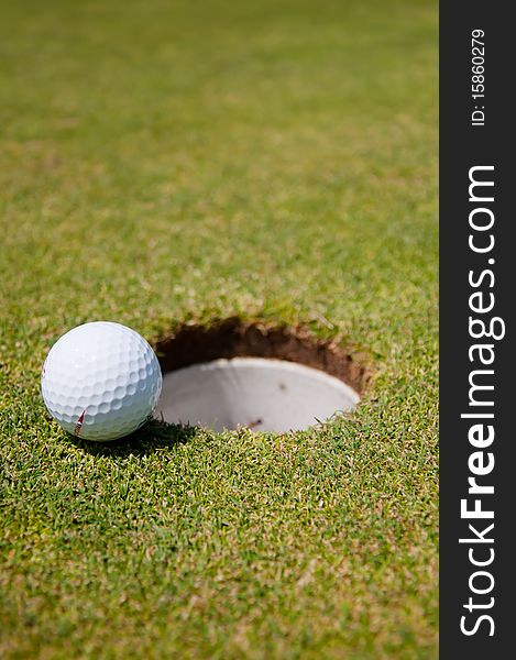 Golf hole with ball in a course
