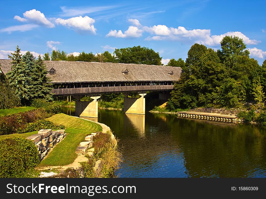 Wooden covered bridge on a large river. Wooden covered bridge on a large river.