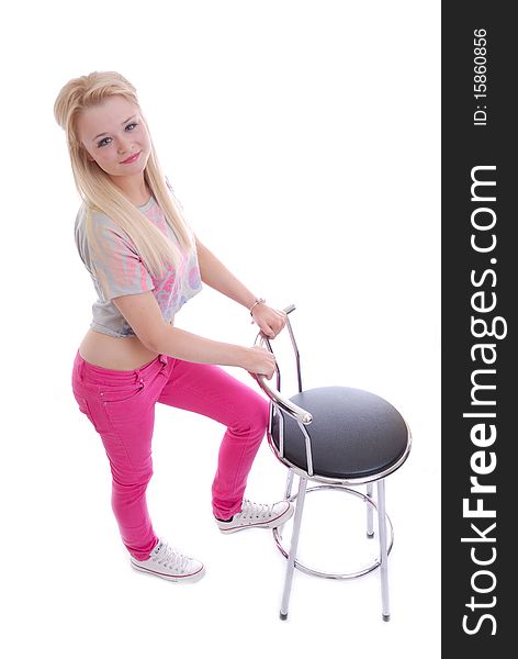 Photograph of pretty young blond girl isolated against white posing with stool. Photograph of pretty young blond girl isolated against white posing with stool