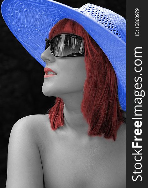 Black and white tinted image of beautiful woman in blue hat. Black and white tinted image of beautiful woman in blue hat