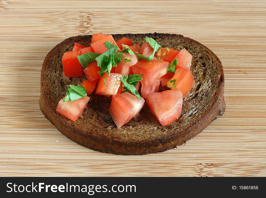 Toast with cut tomato and parsley