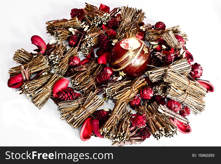 Christmas decorations and candle lit isolated on white