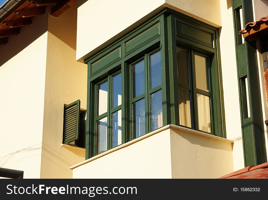 A green wooden balcony in the sun