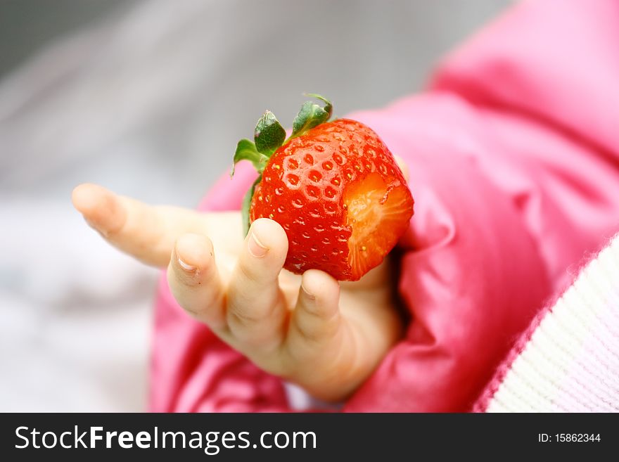 Child Tasting a Strawberry Fruit. Child Tasting a Strawberry Fruit