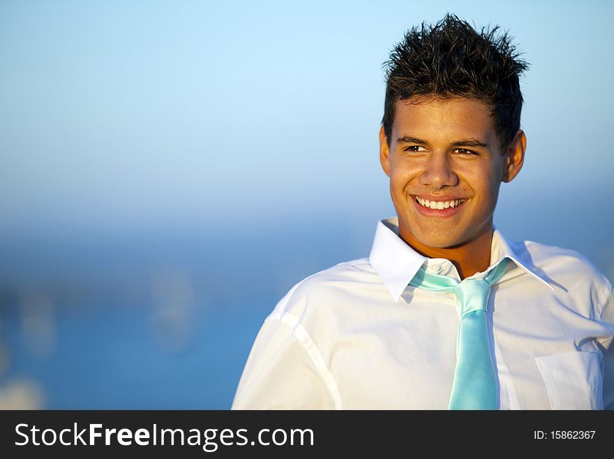 Young man on a pier in a tie at sunset. Young man on a pier in a tie at sunset