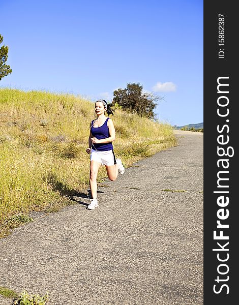 Young woman exercising outside in the sun