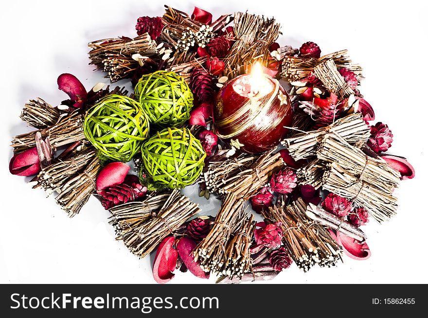 Various christmas decorations with candle lit isolated on white