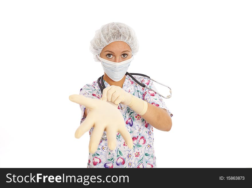 Portrait of young nurse putting on rubber gloves