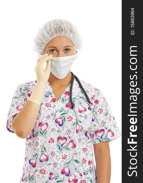 Portrait of young woman nurse in scrubs pulling on mask. Portrait of young woman nurse in scrubs pulling on mask