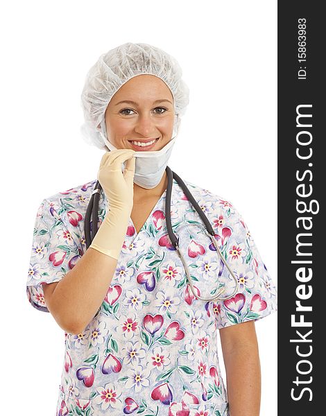 Portrait of young woman nurse in scrubs pulling on mask. Portrait of young woman nurse in scrubs pulling on mask