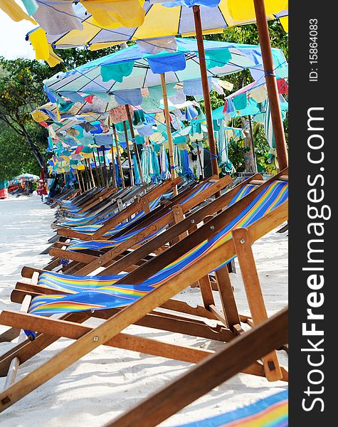 Beach umbrellas and sunbeds at white sandy beach