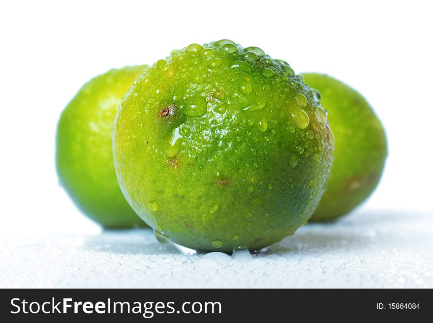 Limes with water drops shot on white background