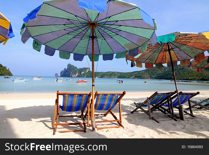 Beach umbrellas and sunbeds at white sandy beach