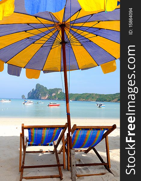 Beach umbrellas and sunbeds at white sandy beach