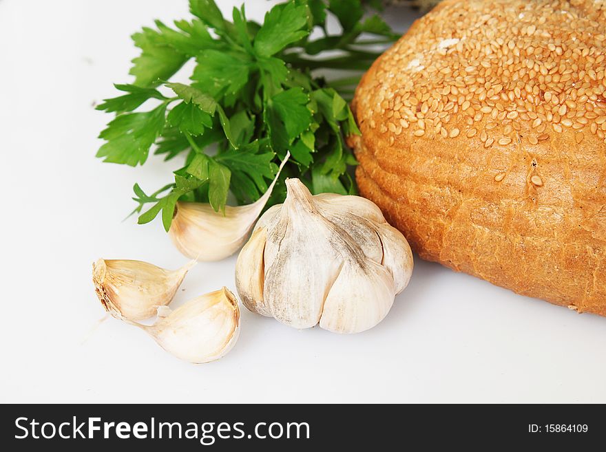 Bread with garlic and parsely on white background