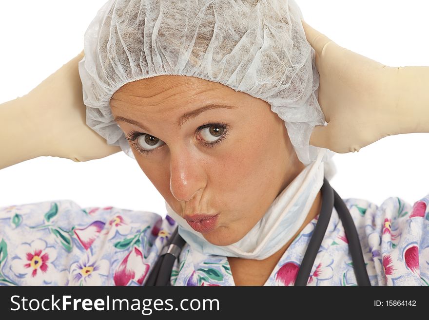 Humorous close-up portrait of young nurse with mask and cap