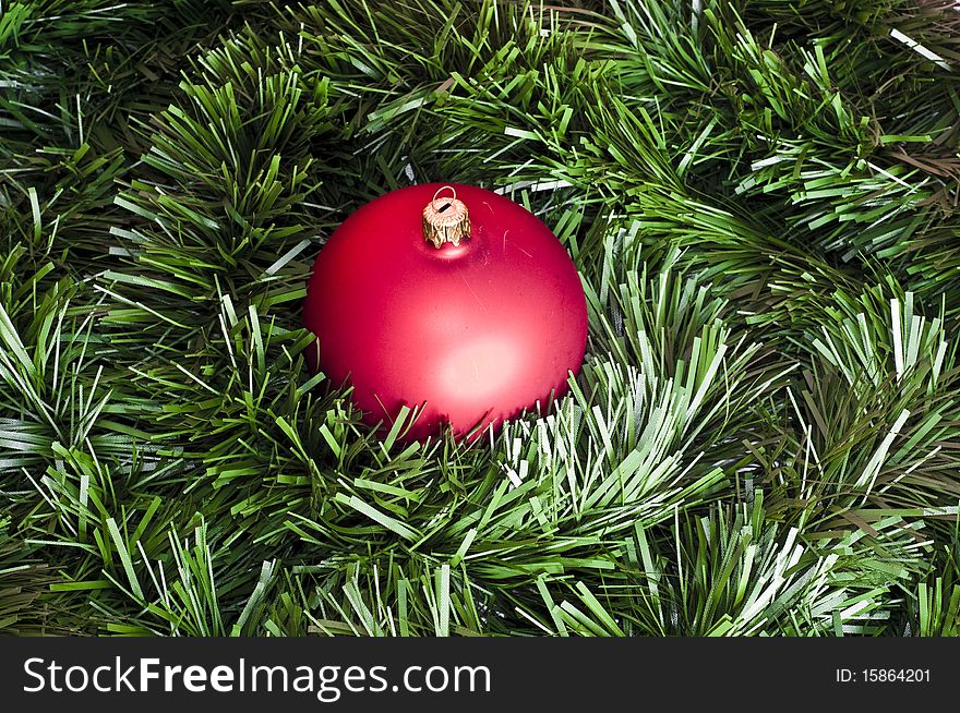 Red bomblet on green christmas chain background