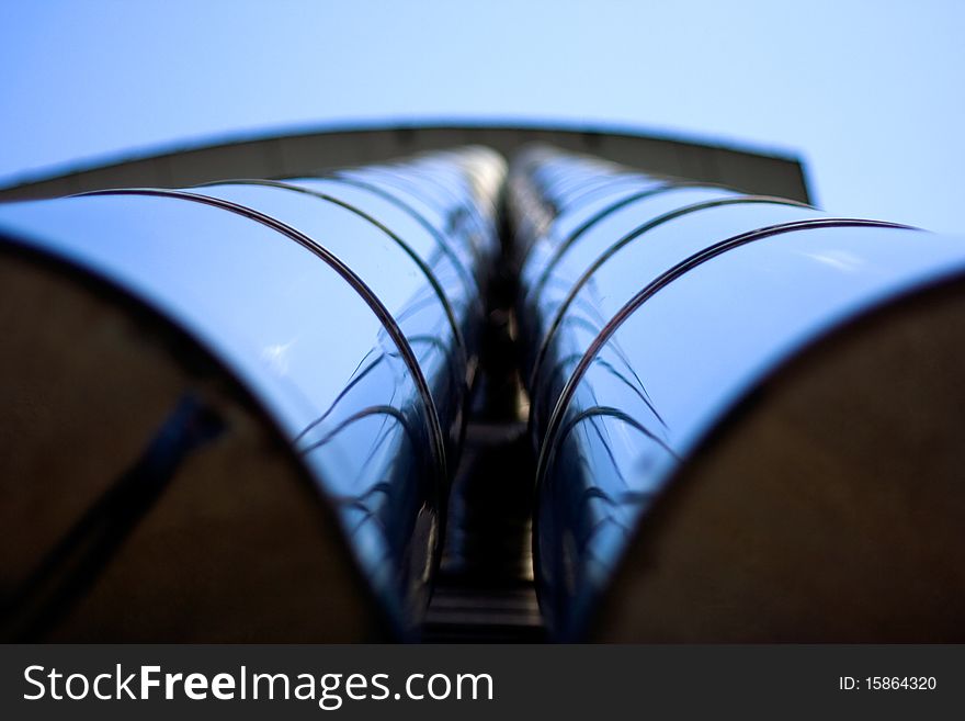 Vertical view of metal tubes on the exterior of a building. Vertical view of metal tubes on the exterior of a building.