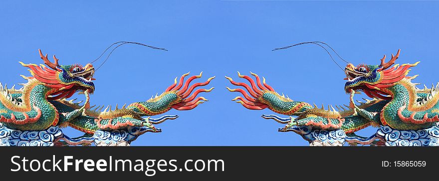 Pair of statue dragon on blue sky background. Pair of statue dragon on blue sky background