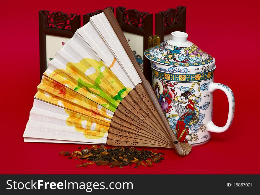 Fan and cup in asian style isolated on red background