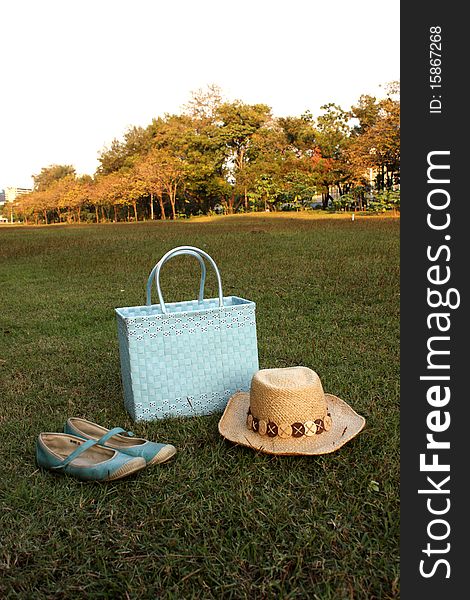 Shoes, hat basket on grass. Shoes, hat basket on grass