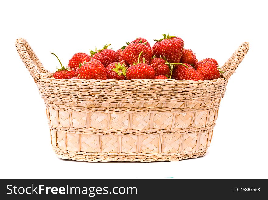 Strawberries in wooden basket isolated on white